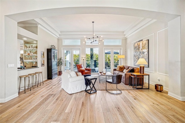 interior space with french doors, light hardwood / wood-style flooring, and a high ceiling