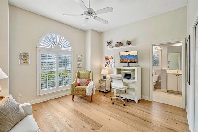 sitting room featuring ceiling fan and light wood-type flooring