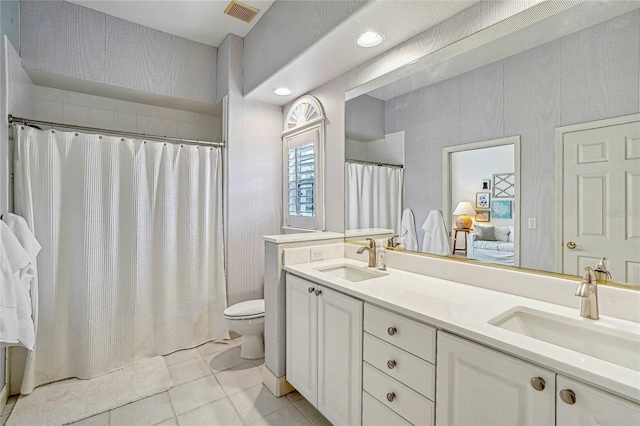 bathroom featuring vanity, tile patterned flooring, curtained shower, and toilet