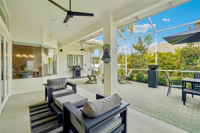 view of patio / terrace with a lanai, area for grilling, and ceiling fan