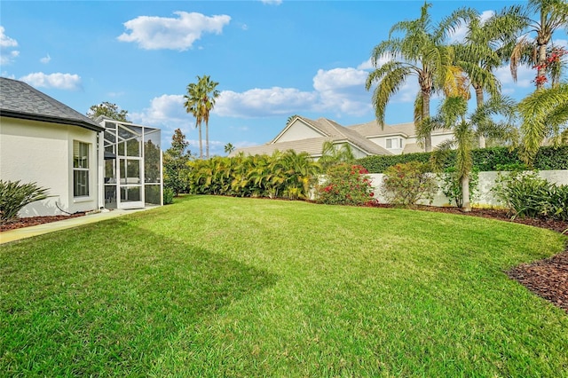 view of yard with glass enclosure