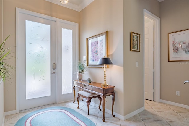 tiled entryway featuring crown molding