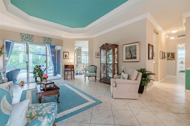 tiled living room with a raised ceiling and crown molding