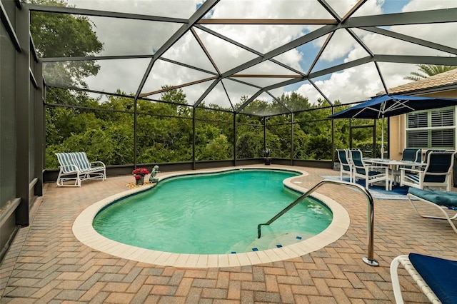 view of pool featuring a patio and glass enclosure