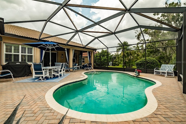 view of swimming pool featuring a lanai, area for grilling, and a patio area