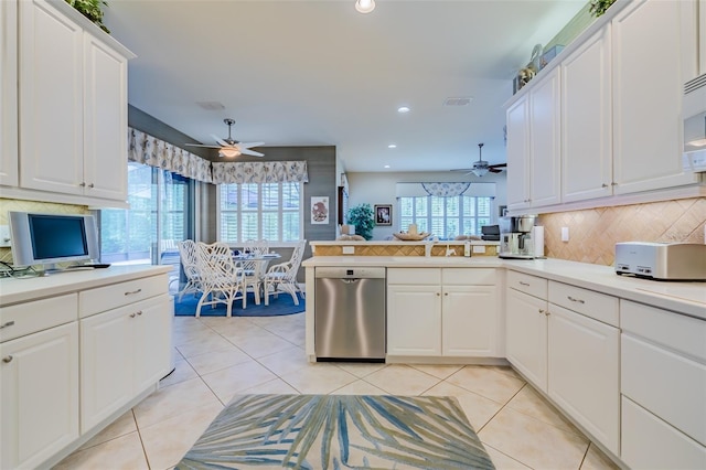 kitchen featuring white cabinetry, dishwasher, light tile patterned floors, kitchen peninsula, and plenty of natural light