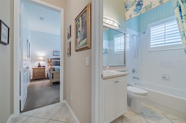 full bathroom featuring vanity, tile patterned floors, toilet, and tiled shower / bath