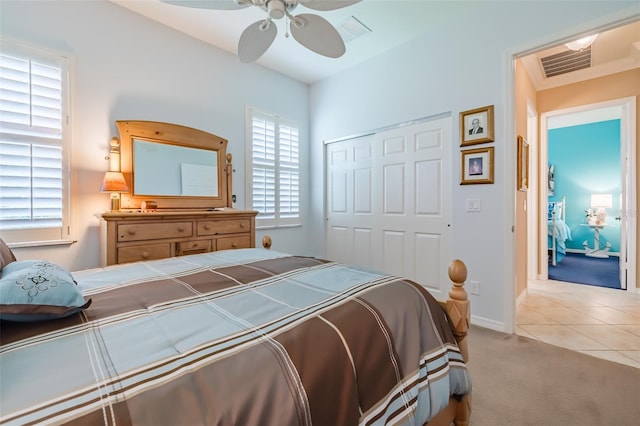 tiled bedroom featuring ceiling fan and a closet