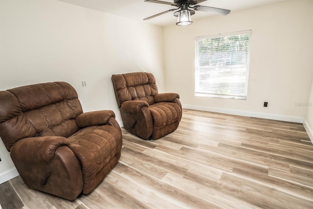 living area with light hardwood / wood-style flooring and ceiling fan