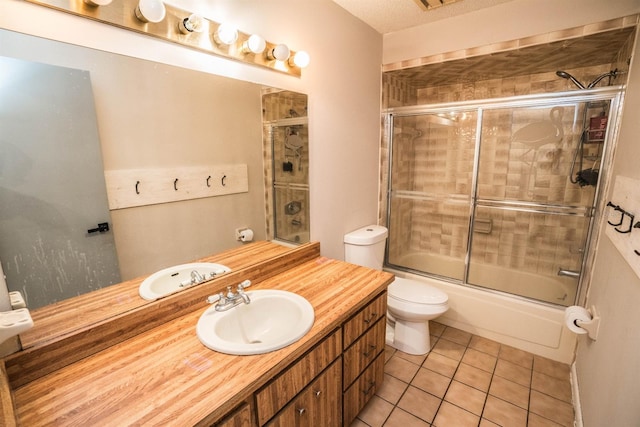 full bathroom featuring tile patterned floors, enclosed tub / shower combo, a textured ceiling, toilet, and vanity