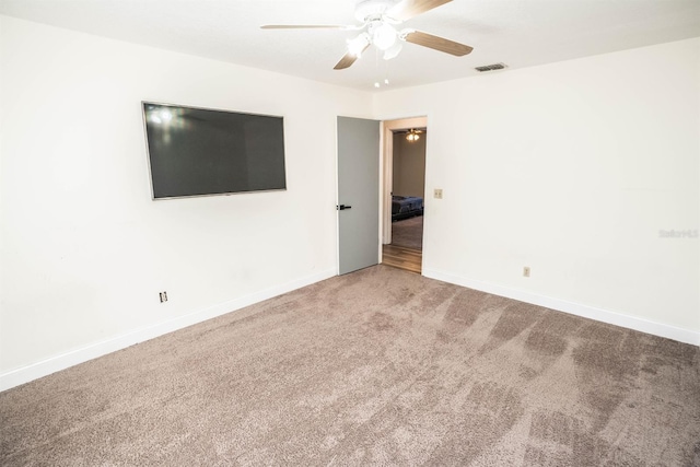 empty room with ceiling fan and carpet floors