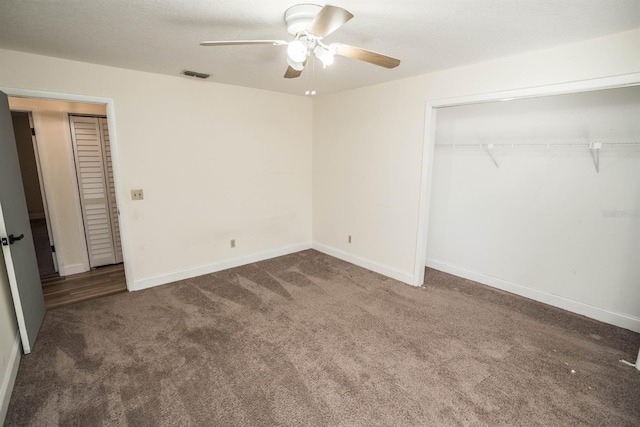 unfurnished bedroom featuring a closet, ceiling fan, and dark carpet