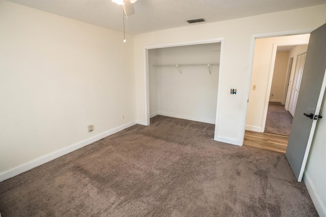 unfurnished bedroom featuring a closet, ceiling fan, and carpet