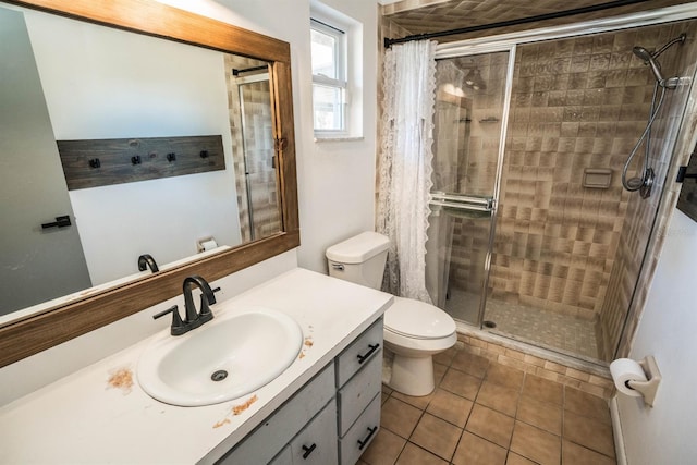 bathroom featuring a shower with door, tile patterned floors, toilet, and vanity