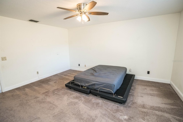 living area with ceiling fan and carpet