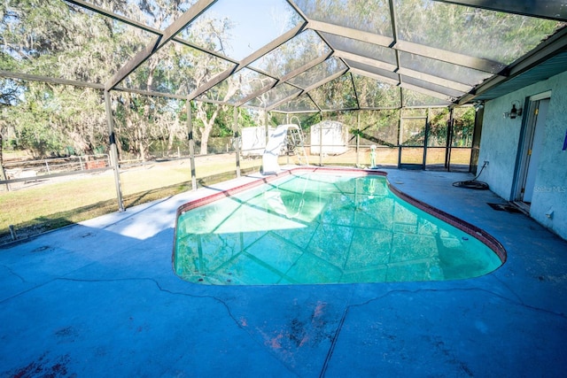 view of pool featuring a lanai, a patio, and a shed