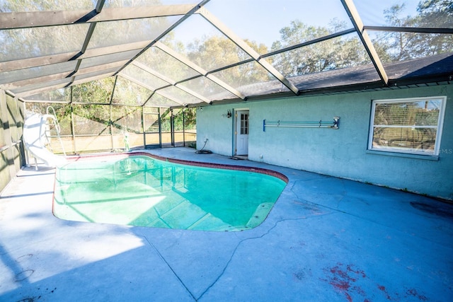 view of swimming pool with a patio area, a lanai, and a water slide