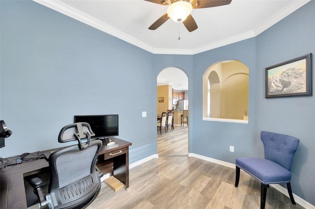 home office with light hardwood / wood-style floors, ceiling fan, and ornamental molding