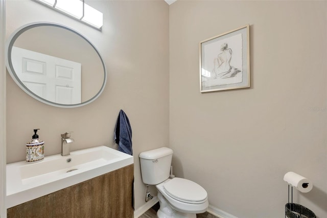 bathroom featuring toilet and vanity