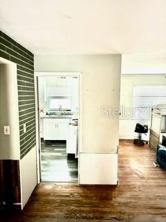 hallway featuring dark hardwood / wood-style flooring and sink