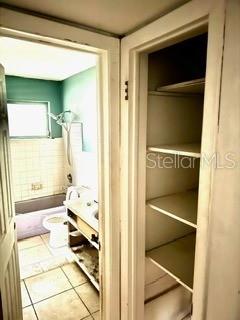 bathroom featuring toilet and tile patterned flooring