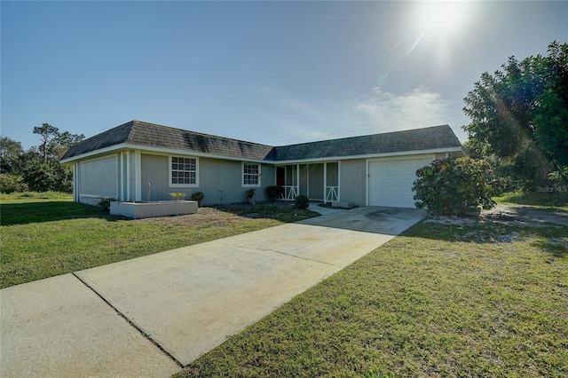 ranch-style home featuring a garage and a front lawn