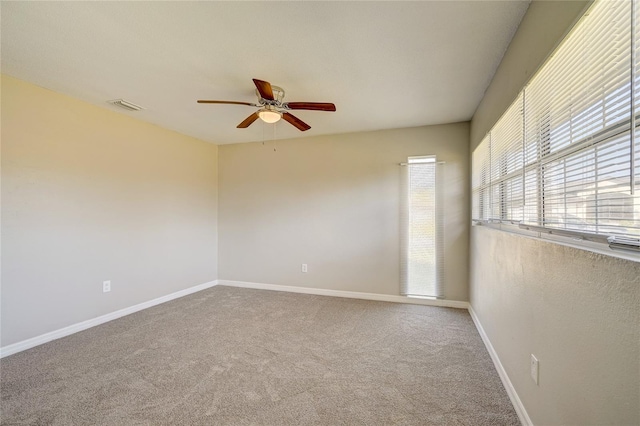 carpeted spare room with ceiling fan