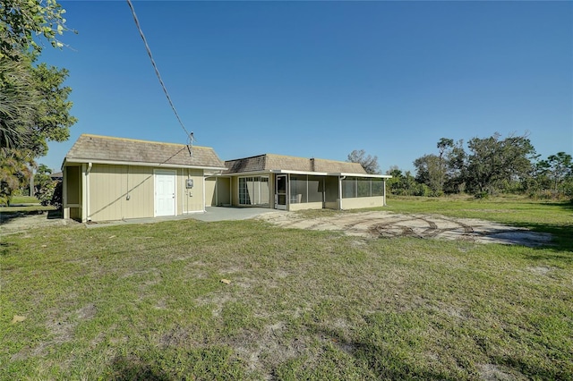 back of property featuring a patio area, a sunroom, and a yard