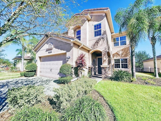 view of front of home with a garage and a front yard