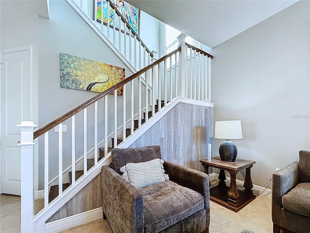 staircase featuring tile patterned flooring