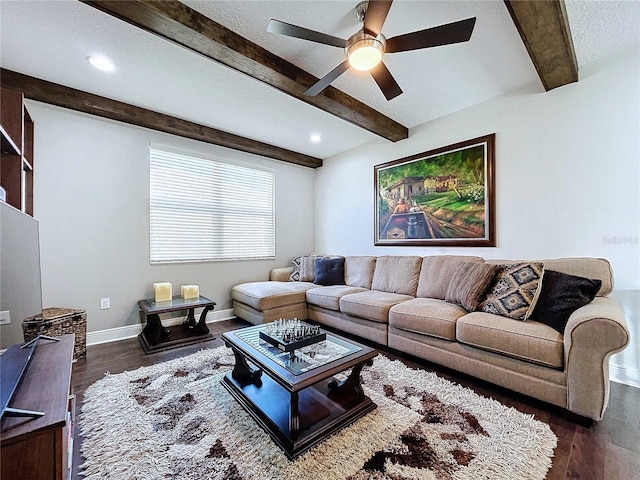 living room with beamed ceiling, dark wood-type flooring, and ceiling fan