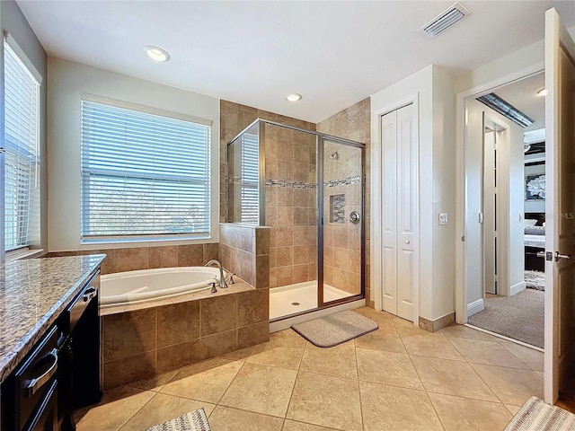 bathroom featuring tile patterned floors, vanity, and plus walk in shower