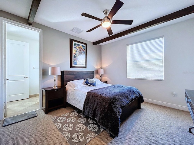 carpeted bedroom featuring beam ceiling and ceiling fan