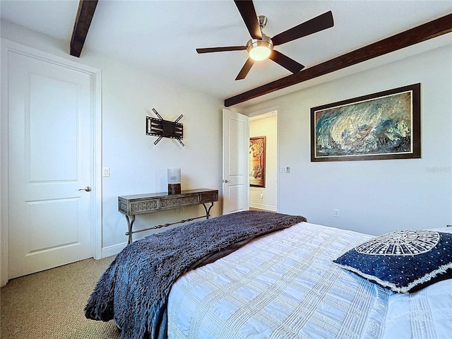 carpeted bedroom with beamed ceiling and ceiling fan