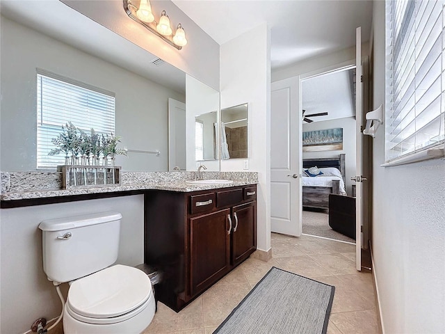 bathroom featuring tile patterned floors, toilet, and vanity