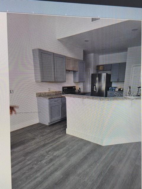 kitchen with stainless steel fridge with ice dispenser and dark hardwood / wood-style flooring