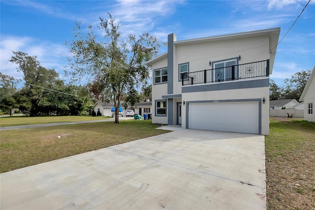 view of front of home featuring a balcony, a garage, and a front lawn