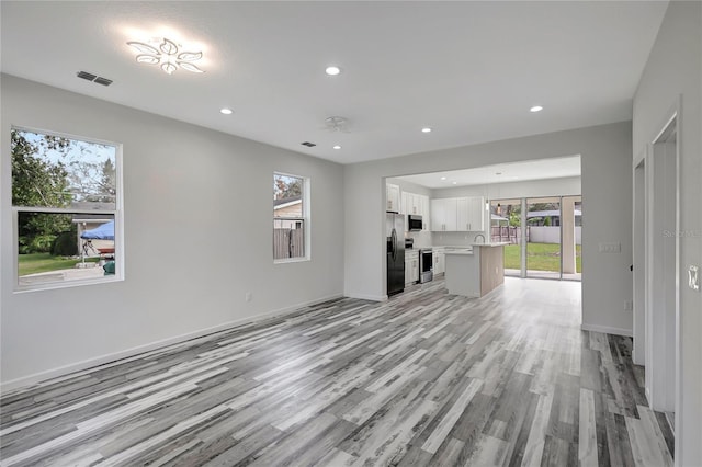 unfurnished living room with light wood-type flooring