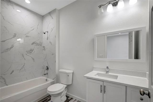 full bathroom featuring vanity, toilet, tiled shower / bath combo, and wood-type flooring