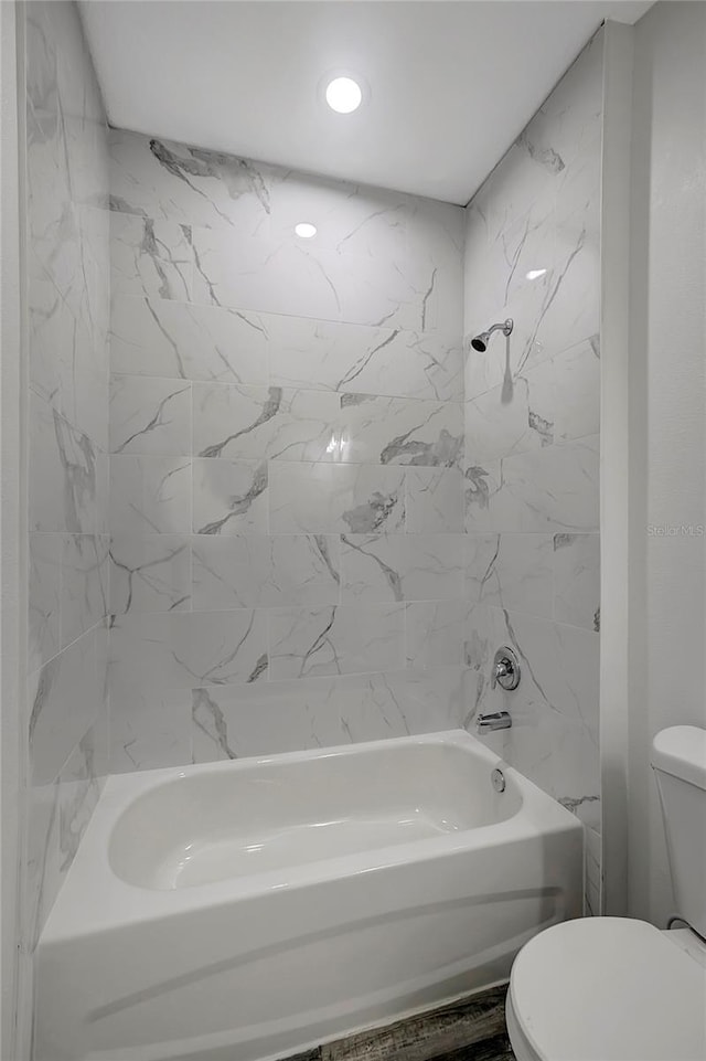 bathroom featuring shower / tub combination, toilet, and hardwood / wood-style floors