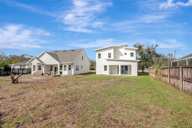 rear view of house featuring a lawn