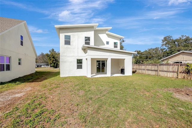 back of house featuring a yard and a patio