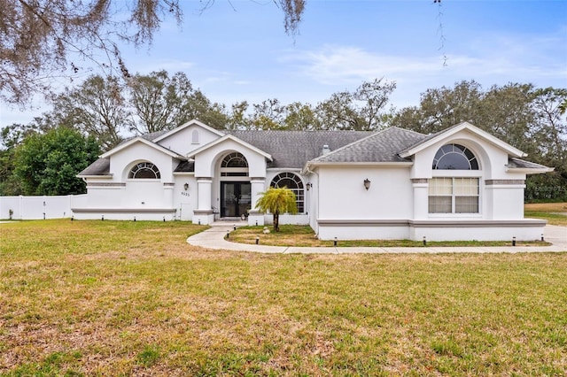 ranch-style home featuring a front lawn