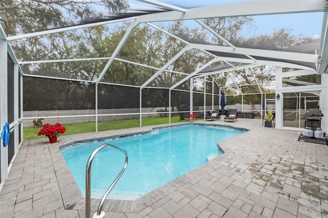 view of swimming pool featuring a patio area and glass enclosure