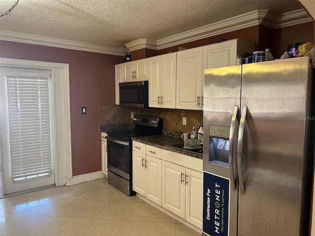 kitchen featuring appliances with stainless steel finishes, crown molding, backsplash, light tile patterned floors, and white cabinetry