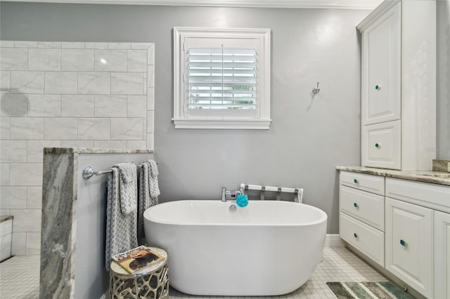 bathroom with vanity, a washtub, and tile patterned flooring