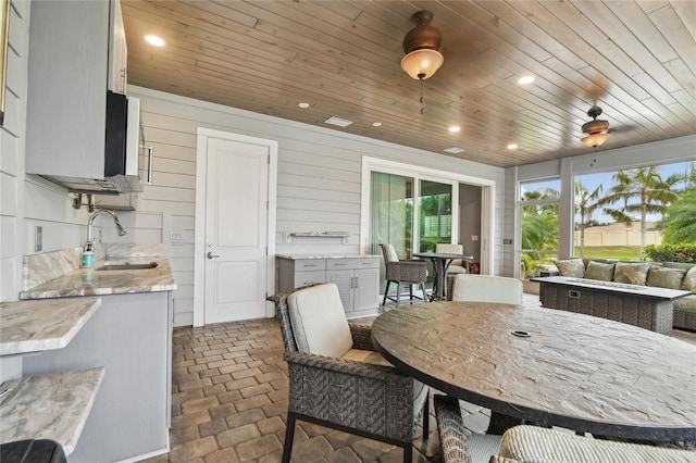 exterior space with sink and wooden ceiling