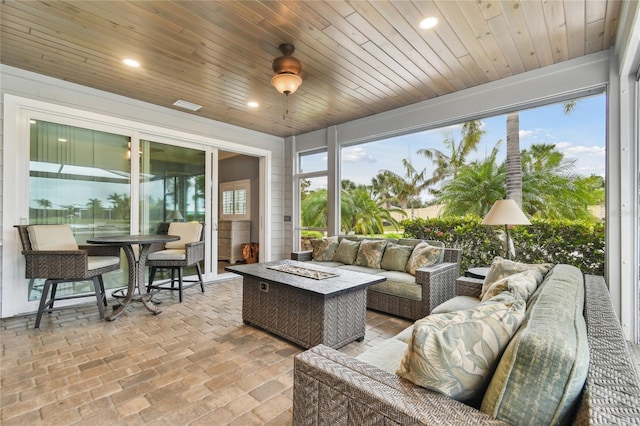 sunroom / solarium featuring wood ceiling and a wealth of natural light