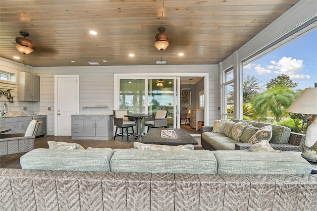 living room with wood ceiling, wood walls, and hardwood / wood-style floors