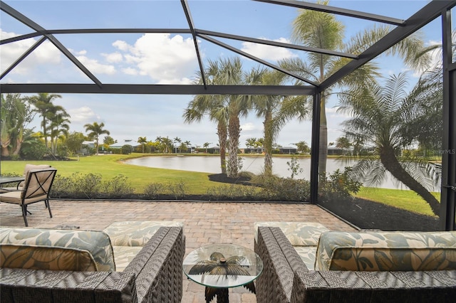 view of patio with a water view and a lanai